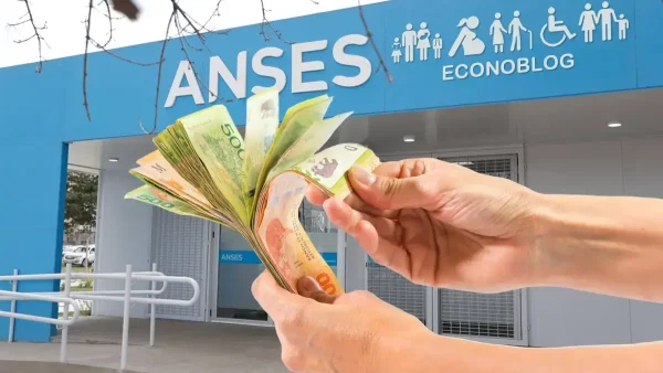 Mano con pesos en oficina de Anses