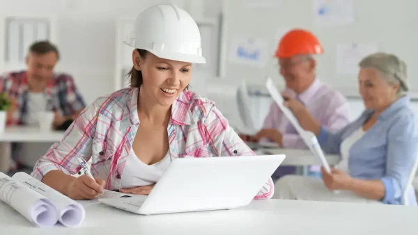 Trabajadora con casco estudiando